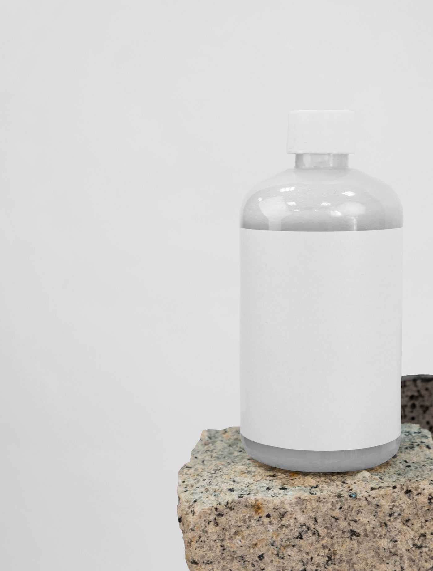 Front View of Rounded Bottle Mockup on Stone FREE PSD