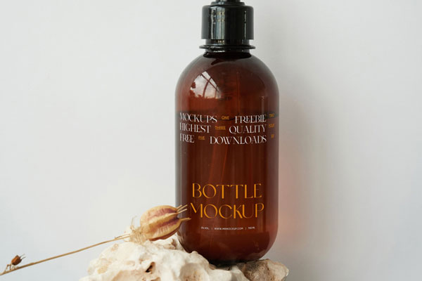 Front View of a Cosmetic Bottle Mockup on a Stone FREE PSD