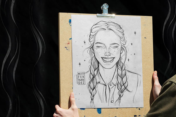 Front View of a Hand Holding Drawing Board Artwork Showcase Mockup FREE PSD