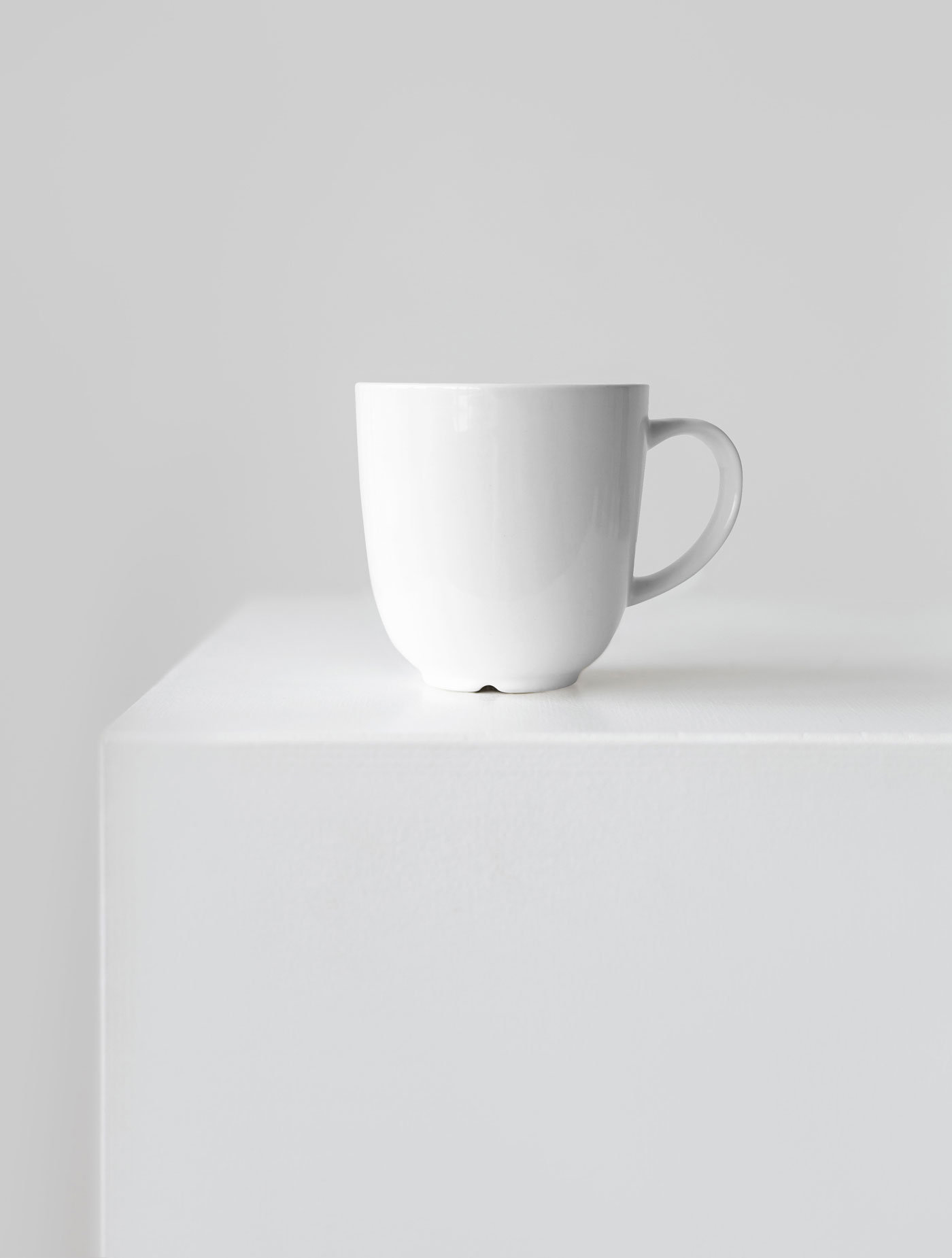 Front View of a Ceramic Mug Mockup on a Cube FREE PSD