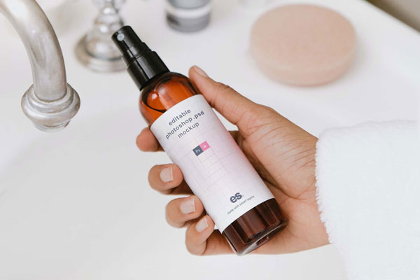 Top View of a Hand Holding Pump Spray Bottle Mockup FREE PSD