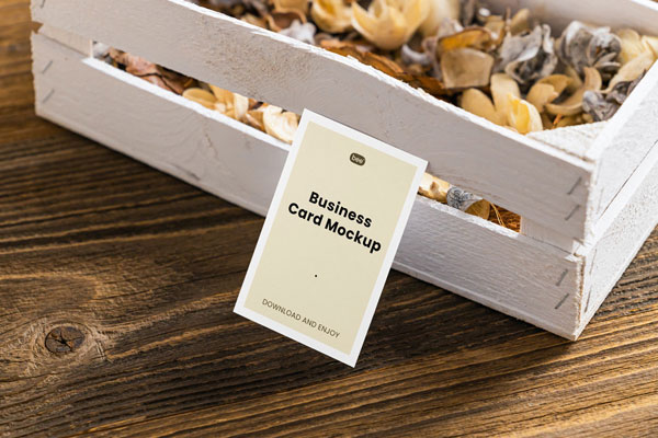 Perspective View of a Business Card Mockup Leaning on a Wooden Box FREE PSD