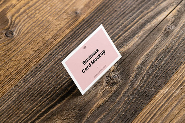 Perspective View of Business Card Mockup in Wood Background FREE PSD
