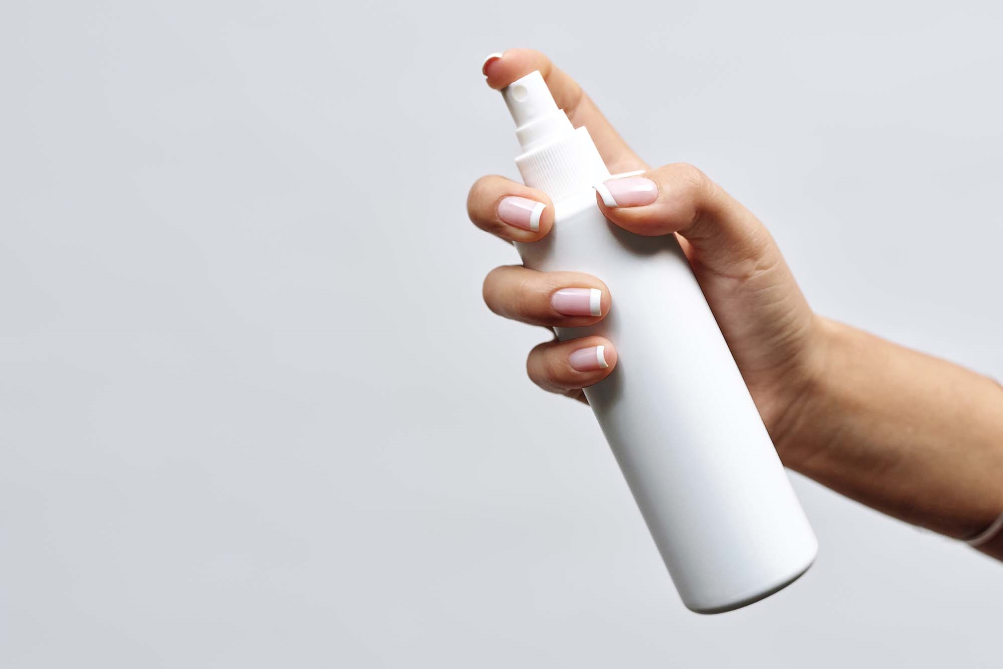 Front View of Hand Holding Lean Spray Bottle Mockup FREE PSD