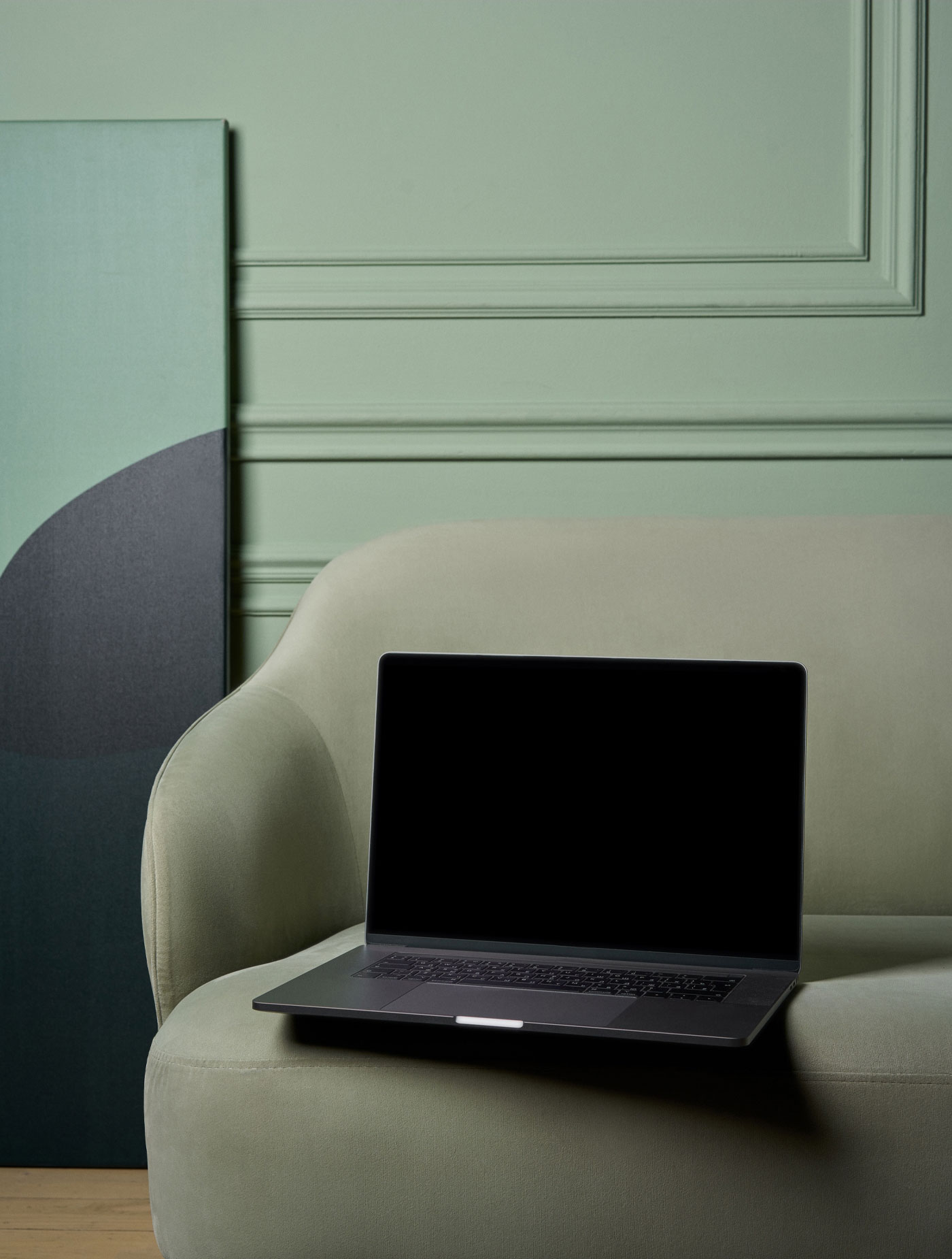 Front View of MacBook Pro Mockup on Couch FREE PSD