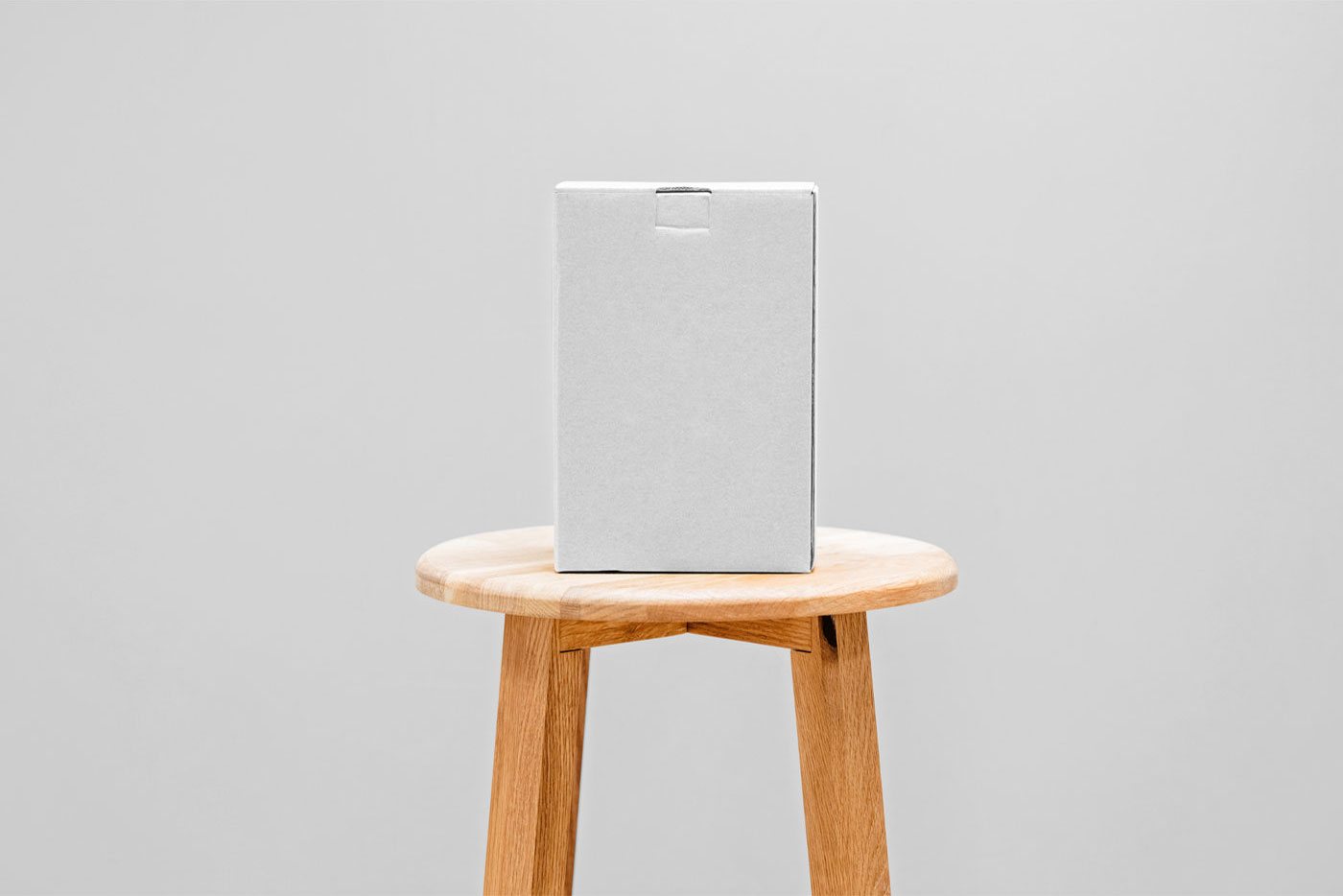 Front View of a Cardboard Box Mockup on a Wooden Chair FREE PSD