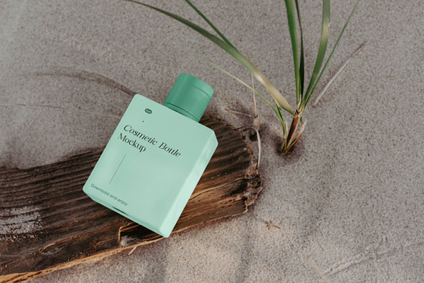 Perspective View of Cosmetic Bottle Mockup on Beach FREE PSD