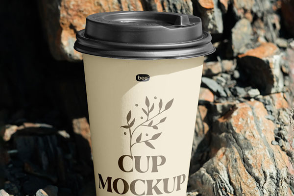 Facing View of Paper Cup Mockup on Rock FREE PSD