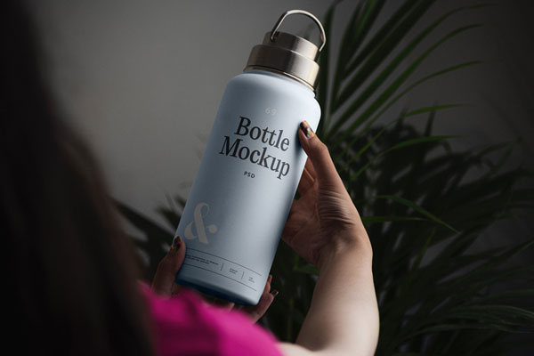 Perspective Vision of Woman Holding Bottle Mockup FREE PSD