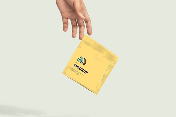 Hand Dropping Paper Bag Mockup in Facing View FREE PSD