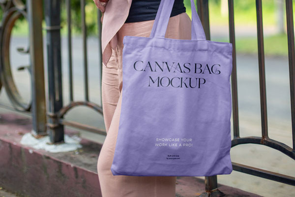 Front View of Woman Holding Canvas Bag Mockup FREE PSD