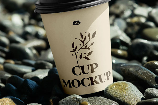 Close-up Sight of Paper Cup Mockup on Stone Beach FREE PSD