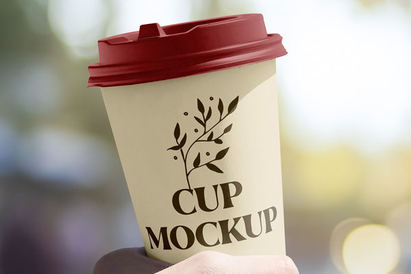 Facing View of Sunny Cup Mockup in Hand FREE PSD