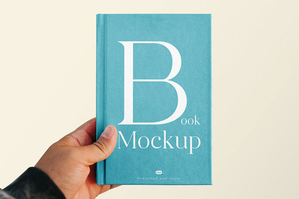 Front Vision of Book Cover Mockup in Hand FREE PSD