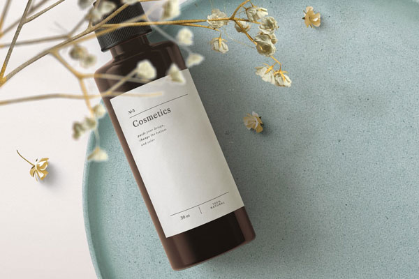 Top View Cosmetics Bottle Mockup on Tray with Flowering Plant FREE PSD
