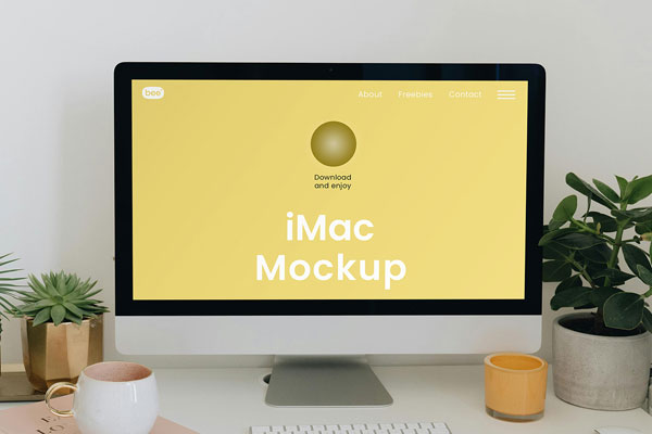 Free Facing Shot of iMac Mockup with Plants PSD Template