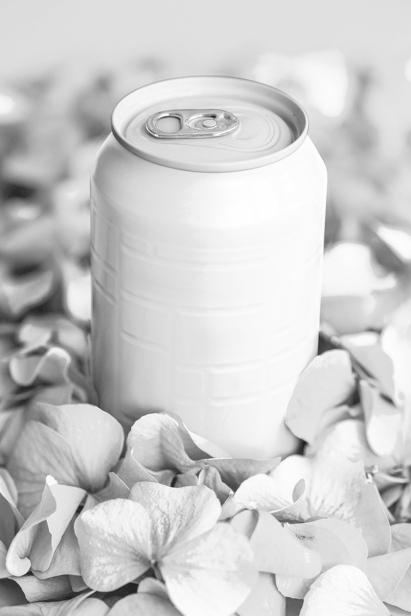 Free Facing Vision of Aluminum Can Mockup in Flower Petals PSD Template