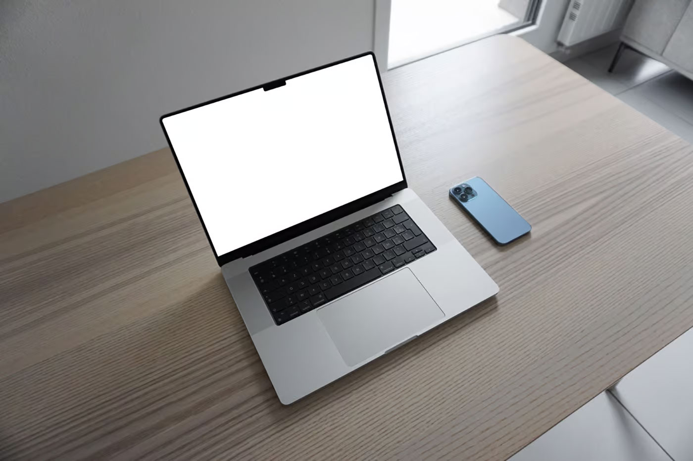 Free Perspective View of MacBook Pro Mockup on Table PSD Template