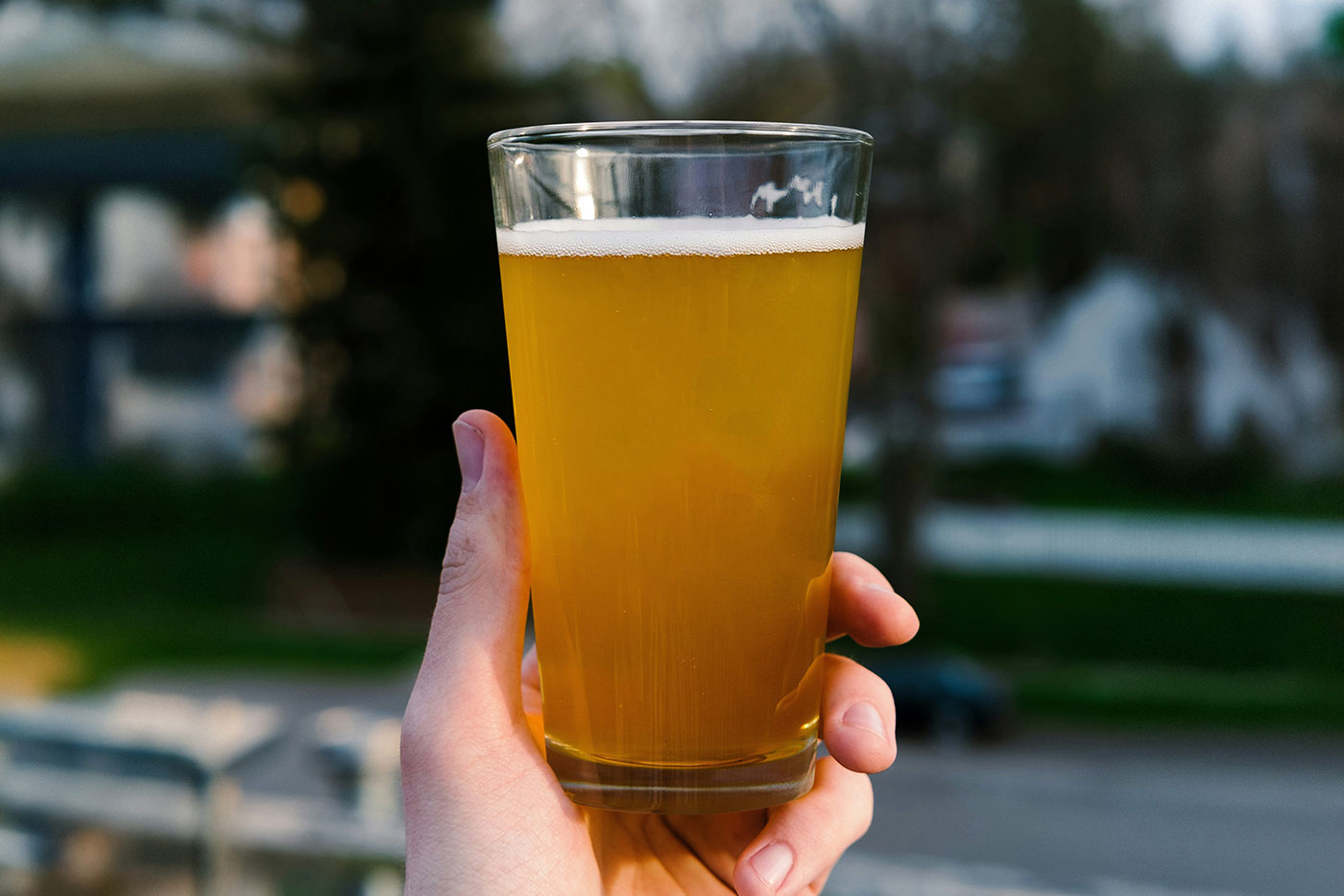 Free Beer Glass in Hand Mockup PSD Template