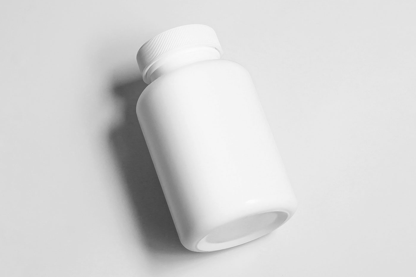 Free Lying Cosmetic Bottle Mockup PSD Template