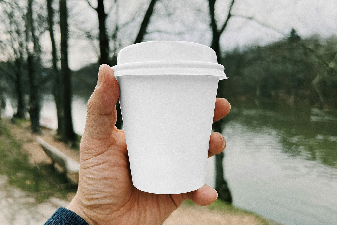 Free Small Paper Cup in Hand Mockup PSD Template