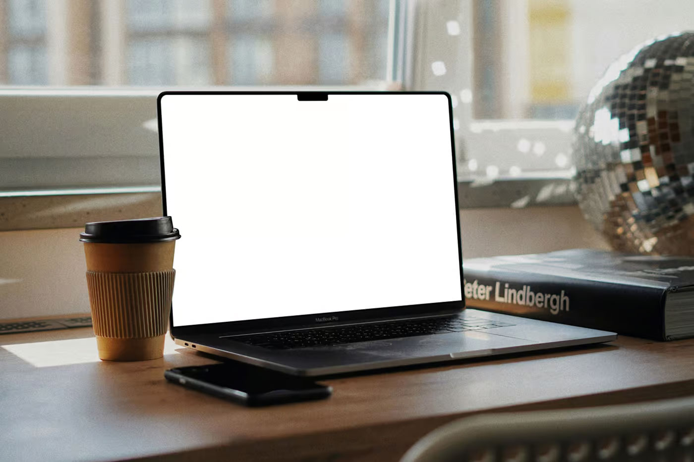 Free MacBook Pro on Writing Desk Mockup PSD Template
