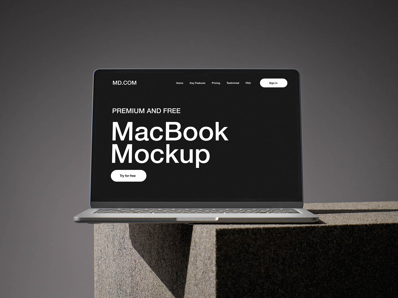 Free MacBook on Concrete Cube Mockup PSD Template