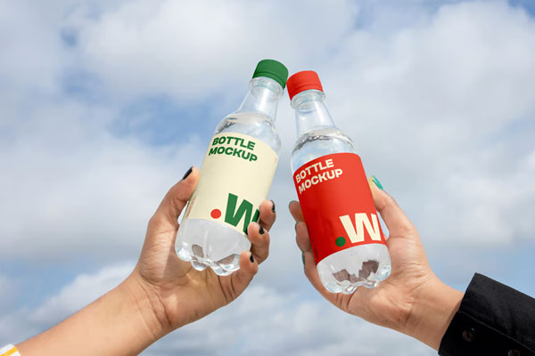 Free Two Bottle in Hand Mockups PSD Template