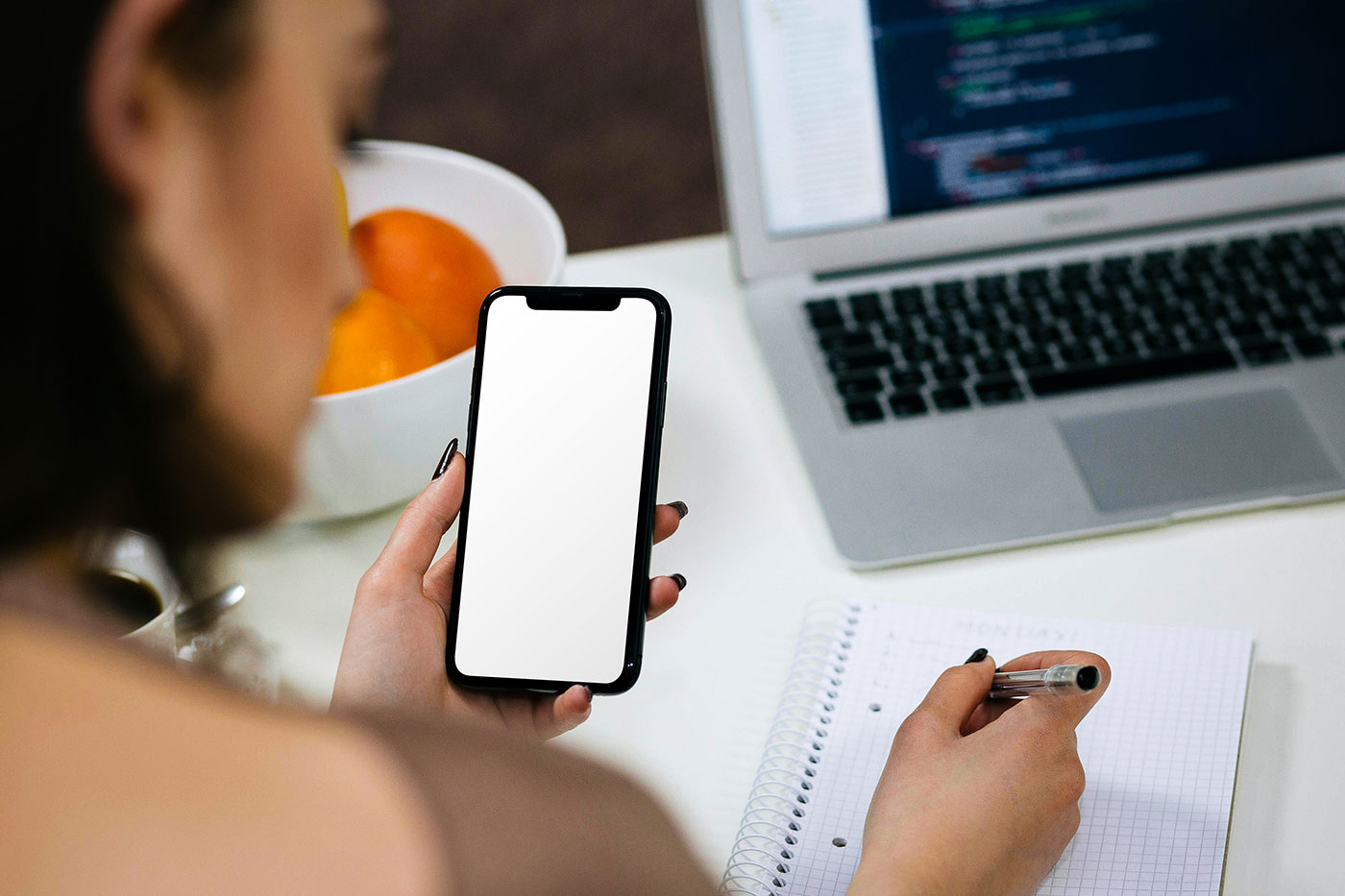 Free iPhone in Woman Hand Mockup PSD Template