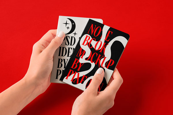 Free Hands Holding Pocket Classic Notebooks Mockup PSD Template