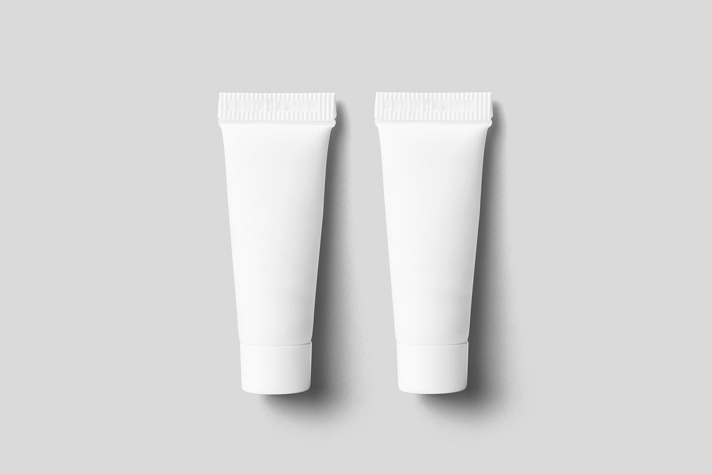 Free Lying Tiny Cosmetic Tube Mockups PSD Template