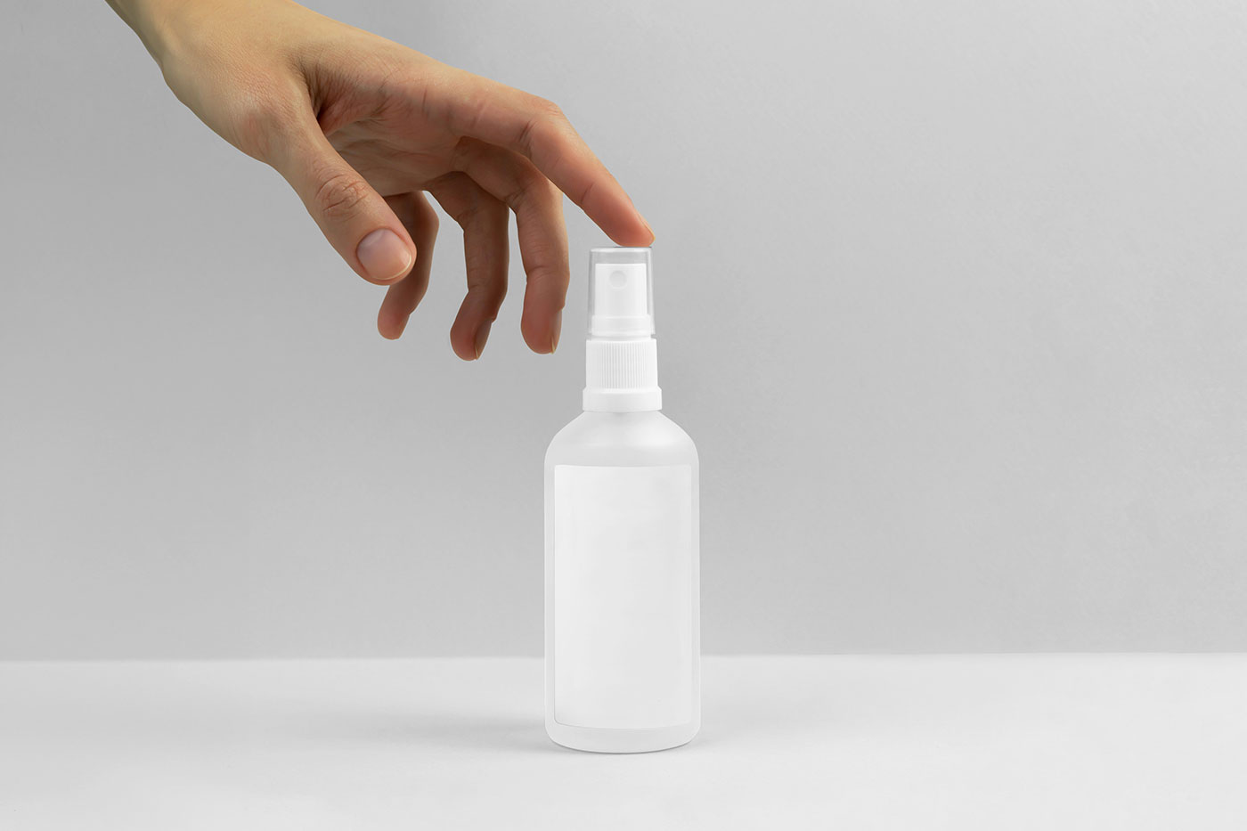 Free Spray Bottle with Hand Mockup PSD Template