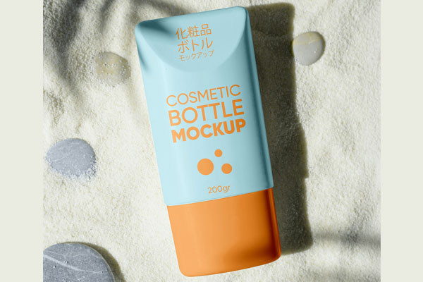 Free Cosmetic Bottle on Sand Mockup PSD Template
