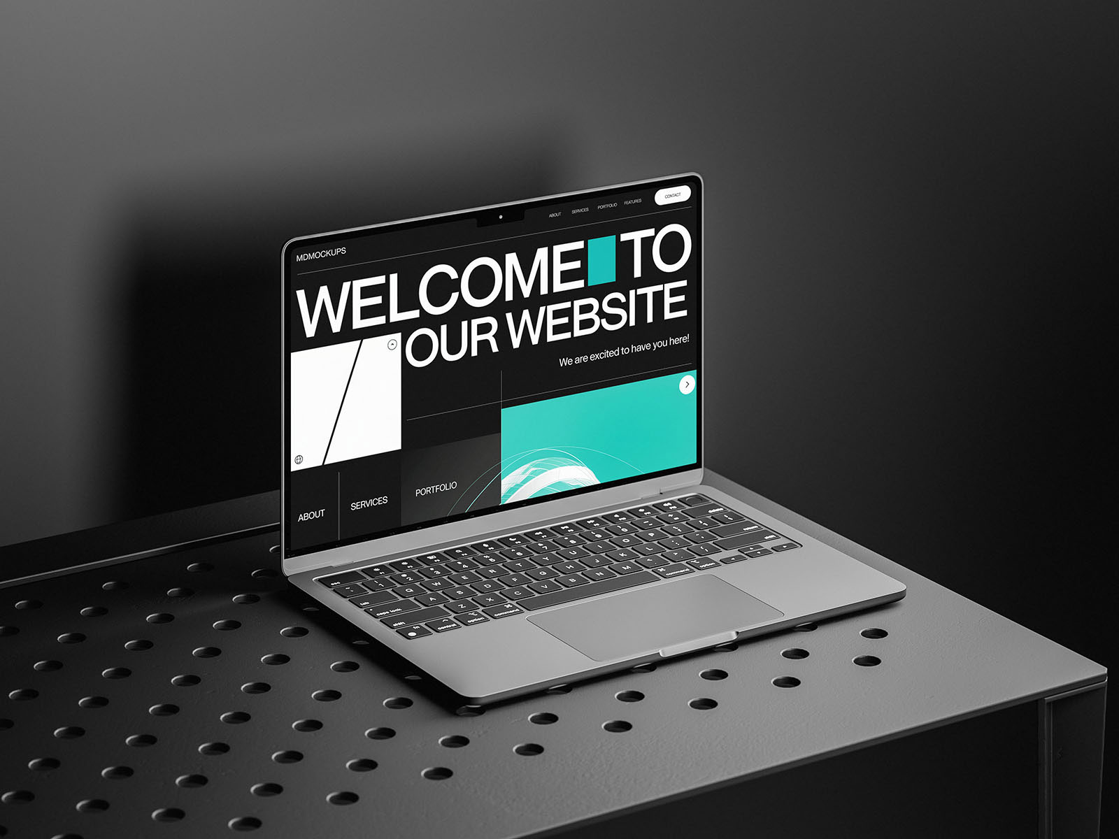 Free MacBook on a Black Table Mockup PSD Template