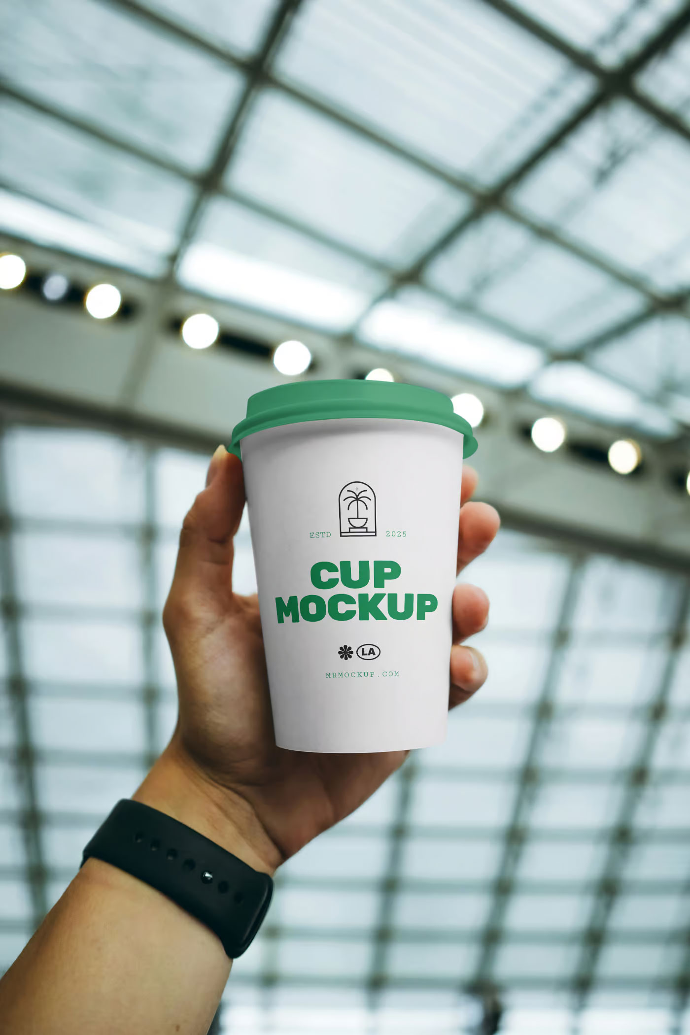 Free Coffee Cup in Hand Mockup PSD Template