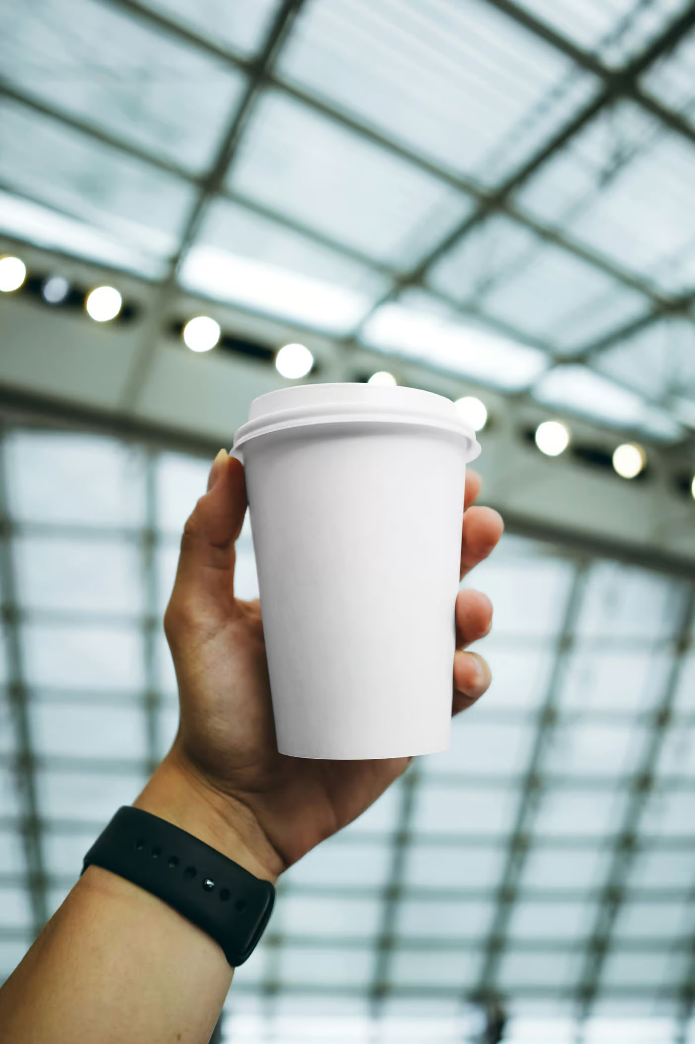 Free Coffee Cup in Hand Mockup PSD Template
