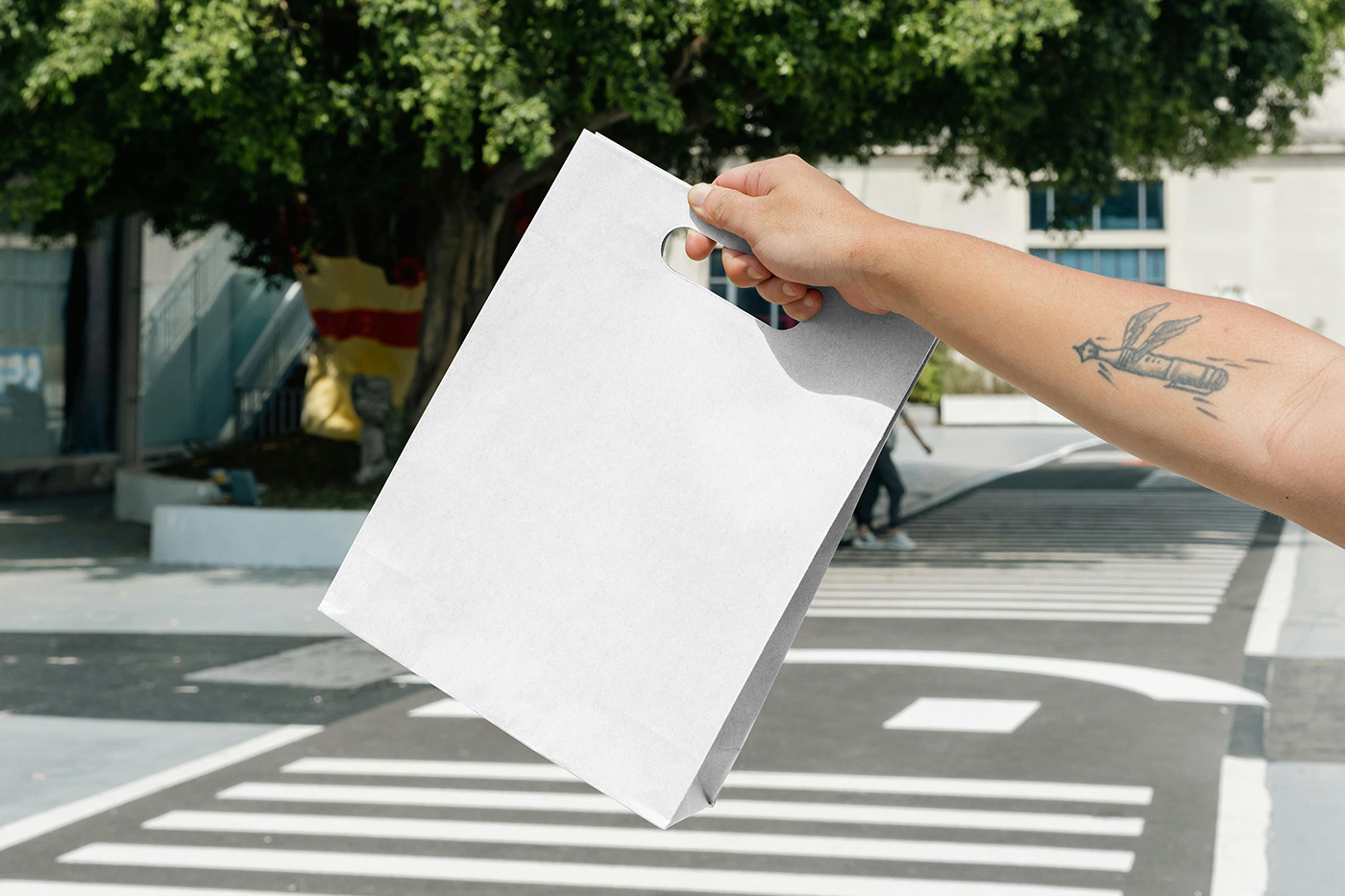 Free Paper Bag in Hand Mockup PSD Template