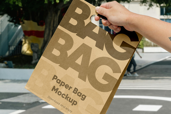 Free Paper Bag in Hand Mockup PSD Template