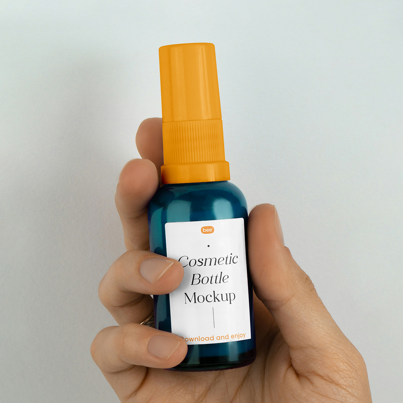 Free Small Spray Bottle in Hand Mockup PSD Template