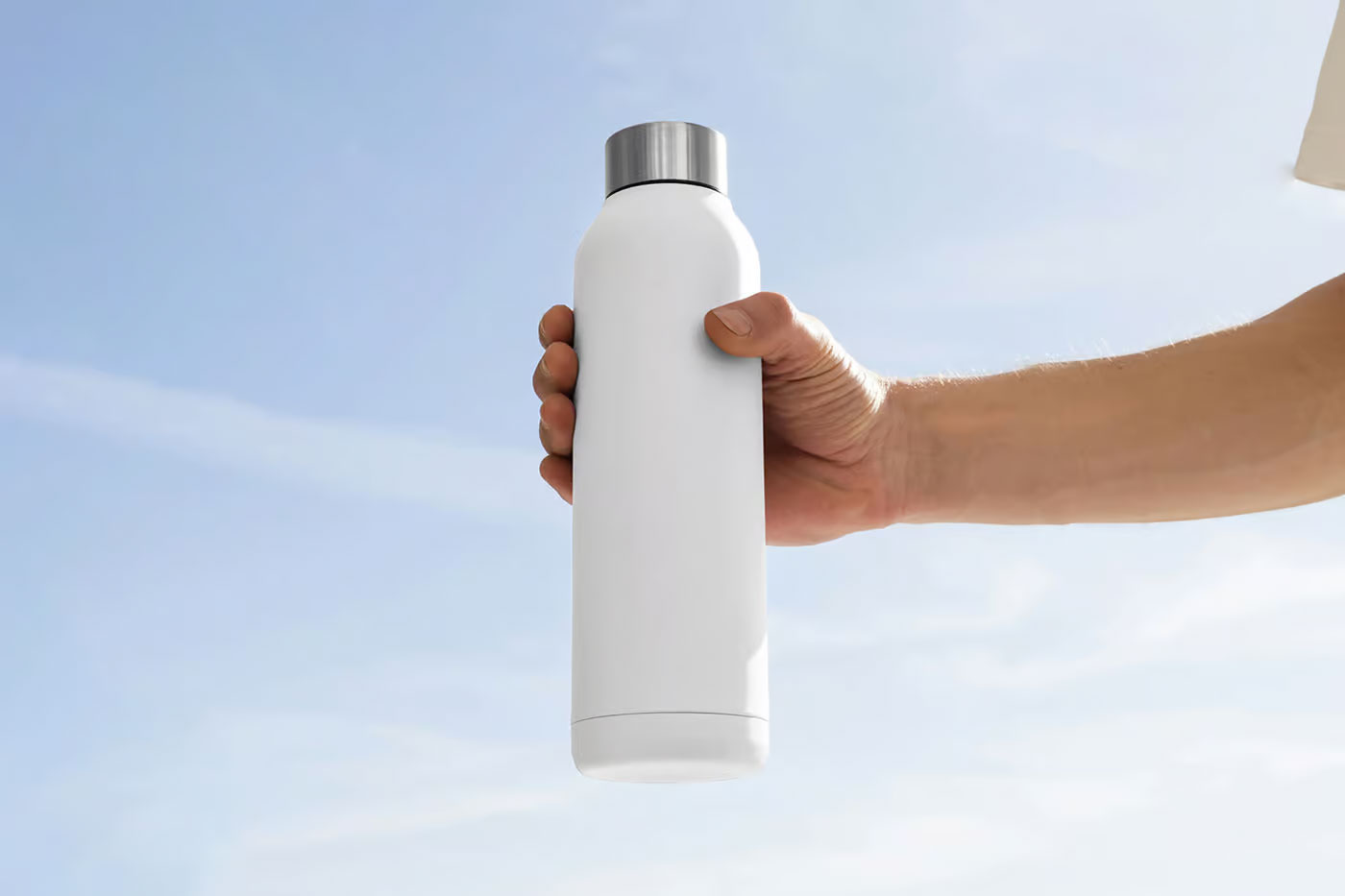 Free Tall Bottle in Hand Mockup PSD Template