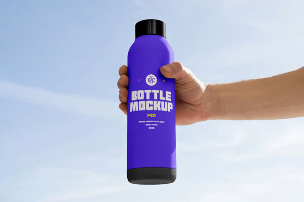 Free Tall Bottle in Hand Mockup PSD Template