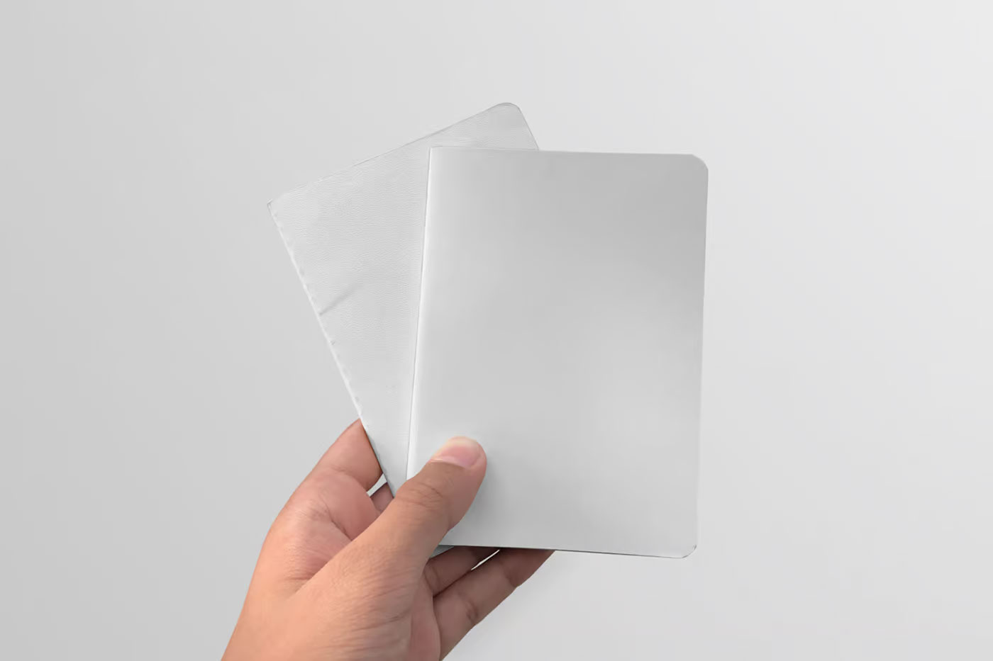 Free Two Notebook in Hand Mockups PSD Template