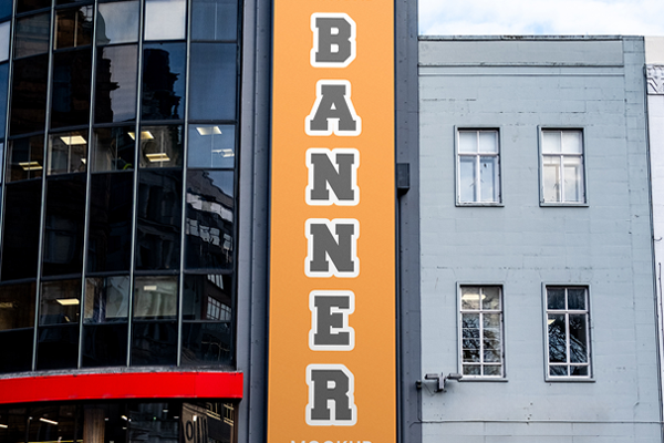Free Vertical Banner in City Mockup PSD Template