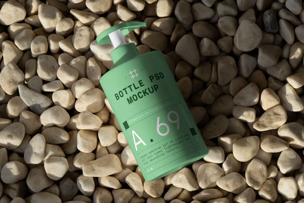 Free Cosmetic Bottle on Beach Mockup PSD Template