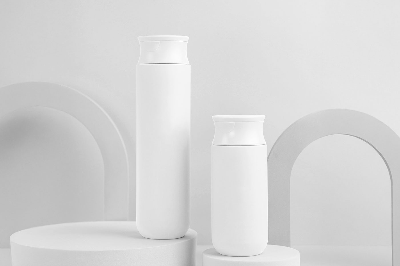 Free Cosmetic Bottles on Stand Mockup PSD Template