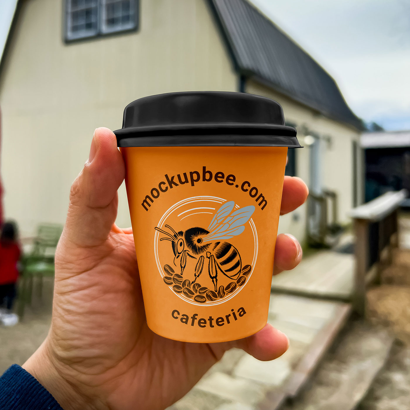 Free Small Coffee Cup in Hand Mockup PSD Template