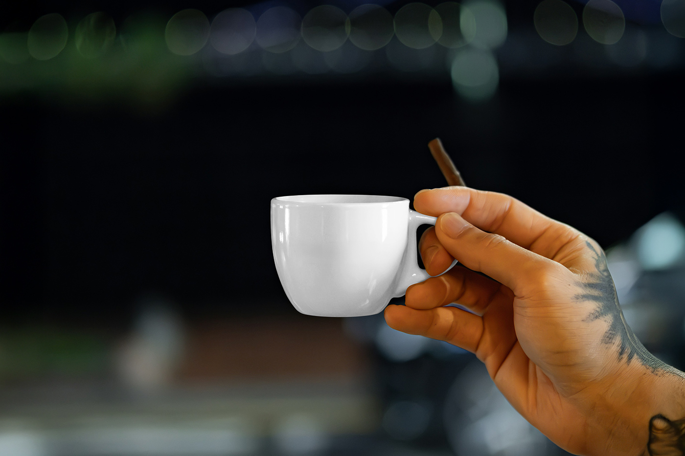 Free Small Porcelain Cup in Hand Mockup PSD Template