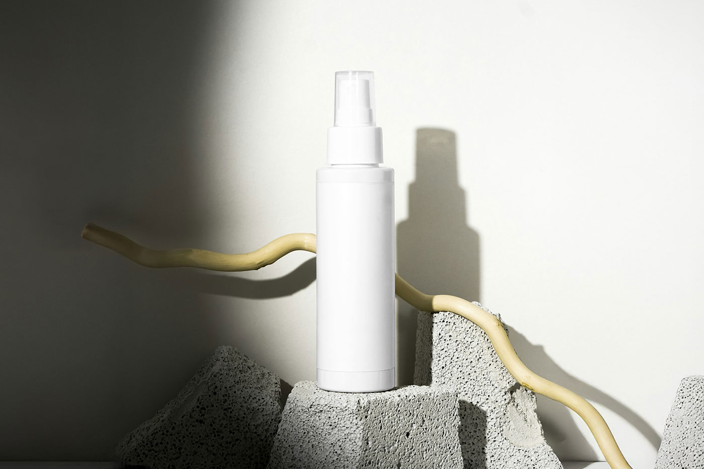Free Spray Bottle on Rock Mockup PSD Template