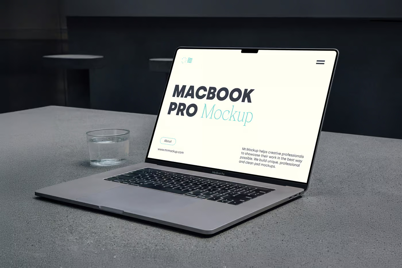 Free MacBook Pro Laying on Concrete Mockup PSD Template