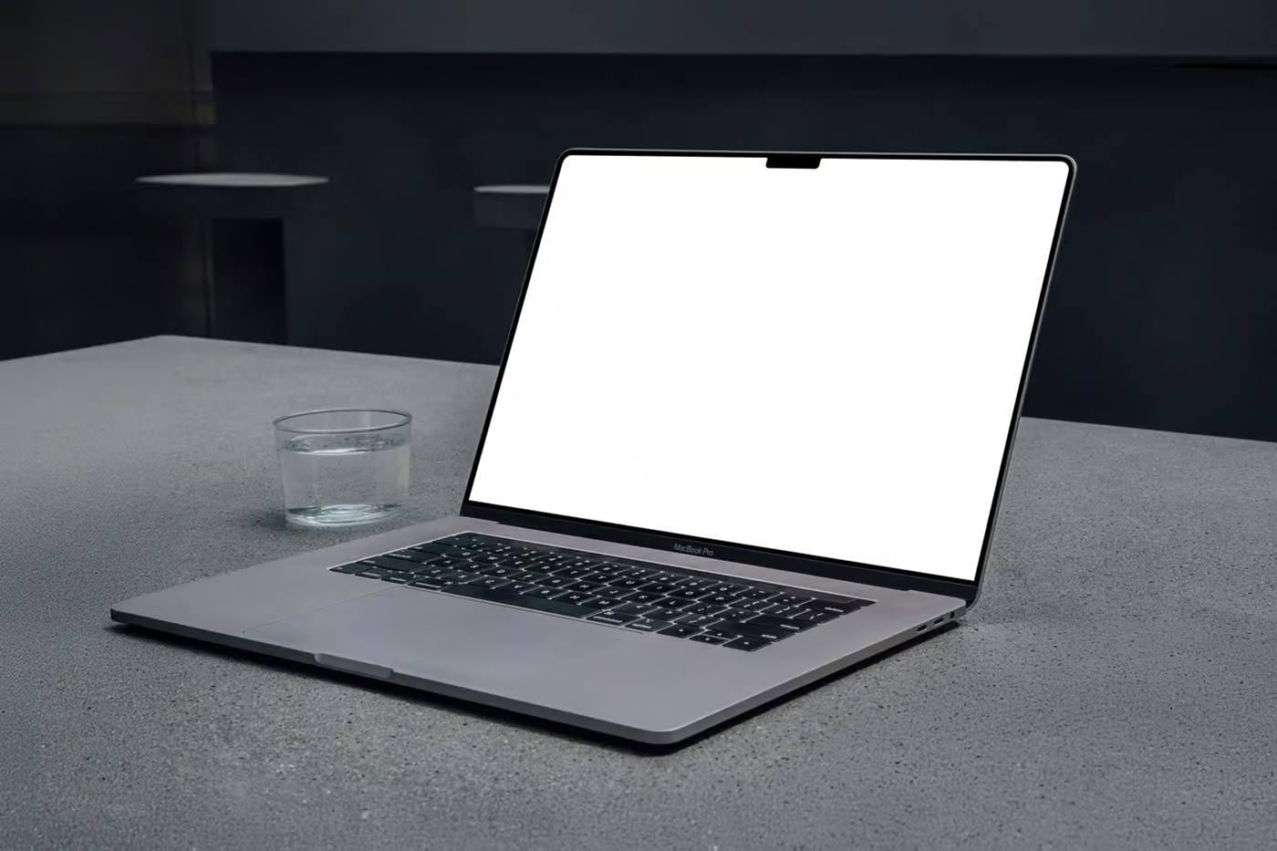 Free MacBook Pro Laying on Concrete Mockup PSD Template